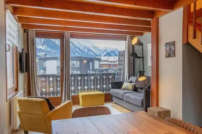 a living room with a view of a mountain at Refuge de l'Aiguille - 2 bedroom duplex in the heart of Chamonix in Chamonix-Mont-Blanc