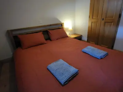 a bedroom with a bed with two pillows on it at Ecrins A4, 1 bedroom apartment with bunk room, central Samoëns in Samoëns