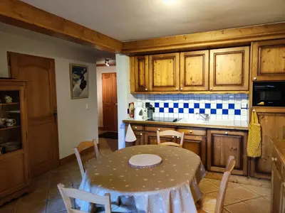 a kitchen with a table and a table and chairs at Spacieux T3, 6 pers, calme, balcon, parking, casier à skis, navette à 150m - FR-1-572-278 in Arâches-la-Frasse