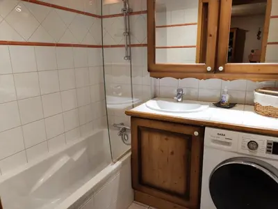a bathroom with a sink and a washing machine at Spacieux T3, 6 pers, calme, balcon, parking, casier à skis, navette à 150m - FR-1-572-278 in Arâches-la-Frasse