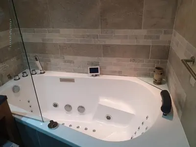 a large white tub in a bathroom at Chalet Ananda avec Sauna, Baignoire Balnéo et Terrasse in Chamonix-Mont-Blanc