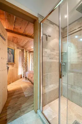a glass shower in a room with a bedroom at Chalet Ananda avec Sauna, Baignoire Balnéo et Terrasse in Chamonix-Mont-Blanc