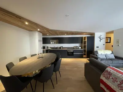 a dining room and living room with a table and a couch at Appartement 5 pièces au pied des pistes, 8 pers, avec parking et WiFi - FR-1-572-277 in Arâches-la-Frasse