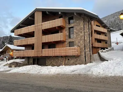 a building with snow in front of it at Appartement 5 pièces au pied des pistes, 8 pers, avec parking et WiFi - FR-1-572-277 in Arâches-la-Frasse