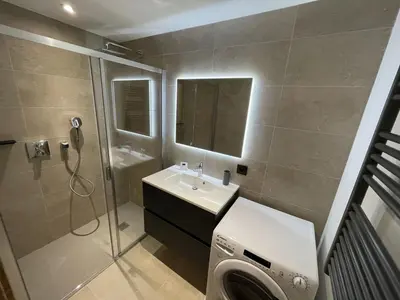 a bathroom with a sink and a shower and a washing machine at Appartement 5 pièces au pied des pistes, 8 pers, avec parking et WiFi - FR-1-572-277 in Arâches-la-Frasse