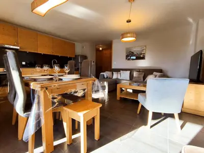 a kitchen and living room with a table and chairs at Appartement lumineux T3 pour 4-6 pers avec WIFI et parking à Samoëns - FR-1-624-128 in Samoëns
