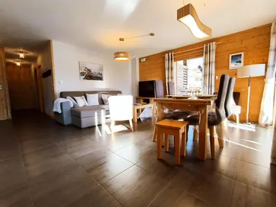 a living room with a table and a couch at Appartement lumineux T3 pour 4-6 pers avec WIFI et parking à Samoëns - FR-1-624-128 in Samoëns