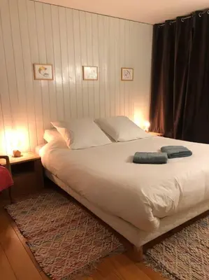 a bedroom with a bed with a blue towel on it at Design loft in Chamonix Center in Chamonix-Mont-Blanc