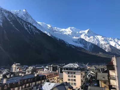 a city with snow capped mountains in the background at Design loft in Chamonix Center in Chamonix-Mont-Blanc