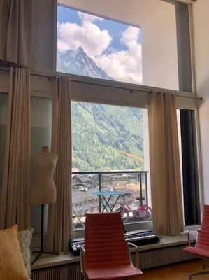 a room with a large window with a view of a mountain at Design loft in Chamonix Center in Chamonix-Mont-Blanc