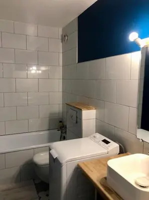 a white bathroom with a toilet and a sink at Design loft in Chamonix Center in Chamonix-Mont-Blanc