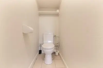 a small bathroom with a white toilet in a stall at Les Pècles Mt Blanc - Chamonix Center in Chamonix-Mont-Blanc