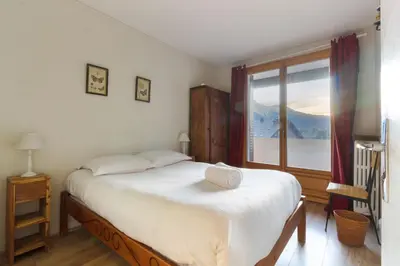 a bedroom with a large bed and a window at Les Pècles Mt Blanc - Chamonix Center in Chamonix-Mont-Blanc