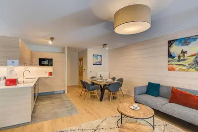 a living room with a couch and a table at White Pearl A13 - Alpes Travel - Central Chamonix (Sleeps 6) in Chamonix-Mont-Blanc