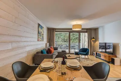 a living room with a table and chairs at White Pearl A13 - Alpes Travel - Central Chamonix (Sleeps 6) in Chamonix-Mont-Blanc