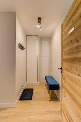 a room with a door and a blue bench at White Pearl A13 - Alpes Travel - Central Chamonix (Sleeps 6) in Chamonix-Mont-Blanc