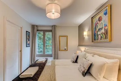 a bedroom with a large white bed with pillows at White Pearl A13 - Alpes Travel - Central Chamonix (Sleeps 6) in Chamonix-Mont-Blanc