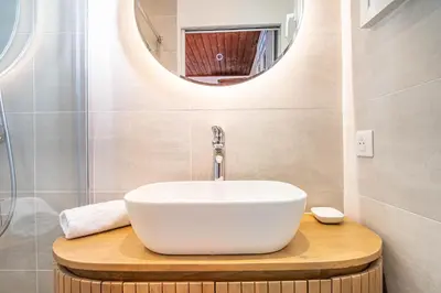 a bathroom with a white sink and a mirror at Primerose - Historic Chalet - Garden - Central - 5 bedrooms - Mont-Blanc Views in Chamonix-Mont-Blanc