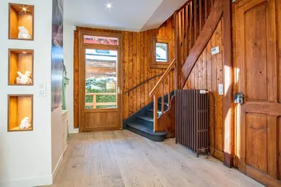 a hallway with wood paneling and a staircase at Primerose - Historic Chalet - Garden - Central - 5 bedrooms - Mont-Blanc Views in Chamonix-Mont-Blanc