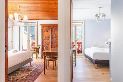 a bedroom with two beds and a desk and a table at Primerose - Historic Chalet - Garden - Central - 5 bedrooms - Mont-Blanc Views in Chamonix-Mont-Blanc