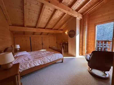 a bedroom with two beds in a wooden cabin at Chalet 4 chambres, 9 pers, pied des pistes, garage 2 voitures - FR-1-572-279 in Arâches-la-Frasse