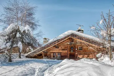 a log cabin with snow on the roof at Chalet Edelweiss in Megève