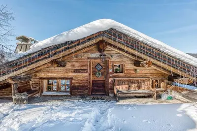 a log cabin with snow on the roof at Chalet Edelweiss in Megève