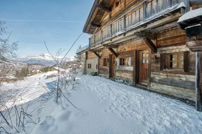 a log cabin with snow on the ground in front of it at Chalet Edelweiss in Megève