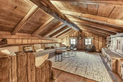 a living room with a couch and a table at Chalet Edelweiss in Megève