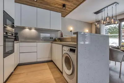 a kitchen with a washing machine in the middle at Kristal in Megève