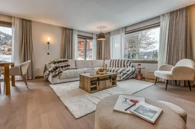 a living room with a couch and a table at Kristal in Megève