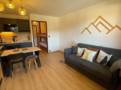 a living room with a couch and a table at Studio familial pour 4 personnes avec parking à Samoëns - FR-1-629-122 in Samoëns