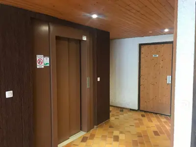 a hallway with two elevators and a wooden door at Studio familial pour 4 personnes avec parking à Samoëns - FR-1-629-122 in Samoëns