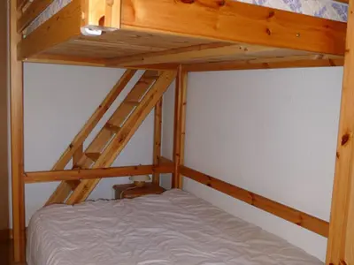 a bunk bed with a ladder on top of it at Appartement cosy à Samoëns avec terrasse et parking - FR-1-629-72 in Samoëns
