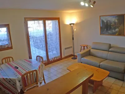 a living room with a couch and a table at Appartement cosy à Samoëns avec terrasse et parking - FR-1-629-72 in Samoëns
