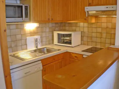 a kitchen with a sink and a microwave at Appartement cosy à Samoëns avec terrasse et parking - FR-1-629-72 in Samoëns