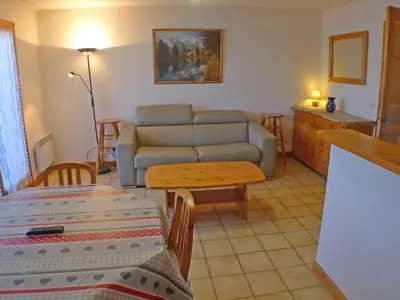 a living room with a couch and a table at Appartement cosy à Samoëns avec terrasse et parking - FR-1-629-72 in Samoëns