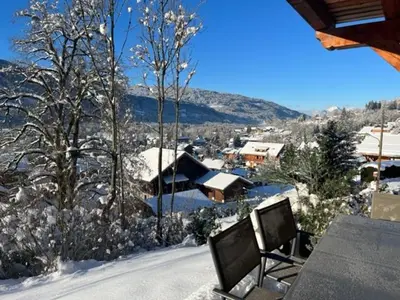 two televisions sitting on a table in the snow at Pom Pom, 3 bedroom apt with stunning mountain views-Samoëns in Samoëns