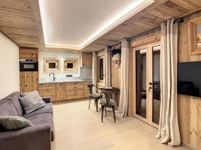 a bedroom with a bed and a large window at Plein soleil in Saint-Gervais-les-Bains