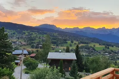 a view of a valley with a house and mountains at Magnifique Chalet neuf 8 pers, 800 m télécabine Princesse Megeve in Combloux