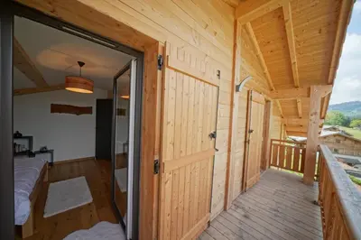 a room with a door leading to a bedroom at Magnifique Chalet neuf 8 pers, 800 m télécabine Princesse Megeve in Combloux