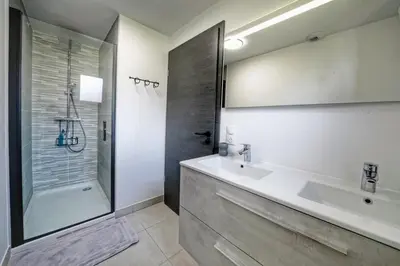 a bathroom with a sink and a shower at Magnifique Chalet neuf 8 pers, 800 m télécabine Princesse Megeve in Combloux