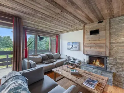 a living room with a couch and a fireplace at Appartement à Megève, proche ski et golf - FR-1-569-67 in Megève