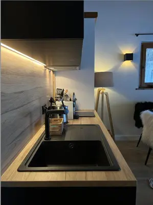 a kitchen with a sink and a table at N5 Megève - Résidence de L'ours - appart 4 pers in Megève