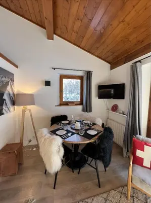 a dining room with a table with black chairs at N5 Megève - Résidence de L'ours - appart 4 pers in Megève