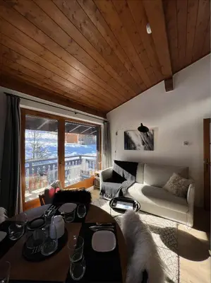 a living room with a couch and a table at N5 Megève - Résidence de L'ours - appart 4 pers in Megève