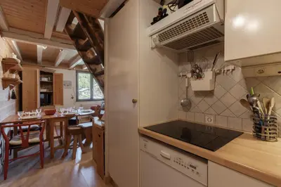 a kitchen and dining room with a dining table at Cristal des Glaces 2 - Lac de Gailland - Randonnée - Escalade - Central in Chamonix-Mont-Blanc