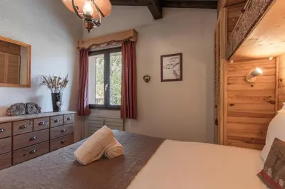 a bedroom with a large bed and a window at Cristal des Glaces 2 - Lac de Gailland - Randonnée - Escalade - Central in Chamonix-Mont-Blanc