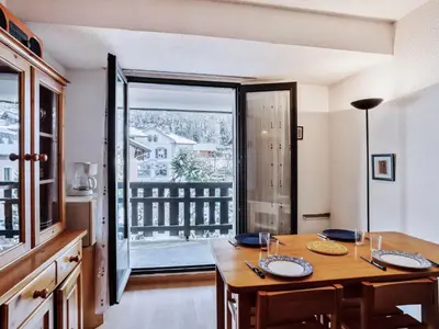 a dining room with a wooden table and chairs at Apartment La Comtesse-10 by Interhome in Saint-Gervais-les-Bains