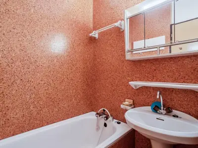 a bathroom with a sink and a tub and a mirror at Apartment La Comtesse-10 by Interhome in Saint-Gervais-les-Bains